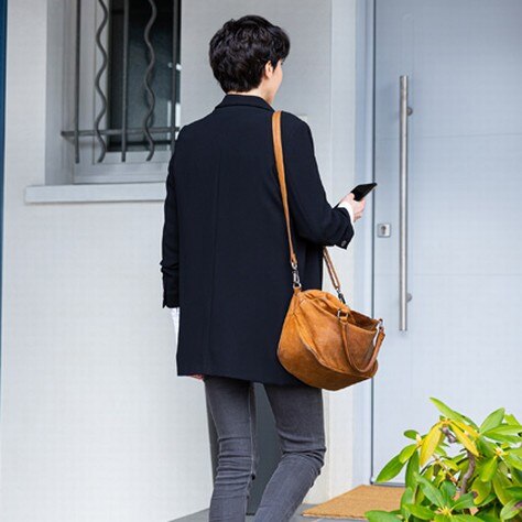 Woman in front of her house